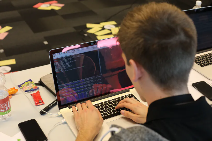 Hacker intently working on his notebook