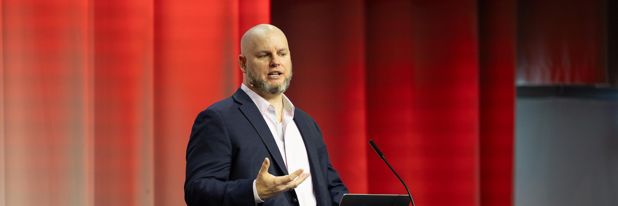 Daniel Miessler talking at the podium